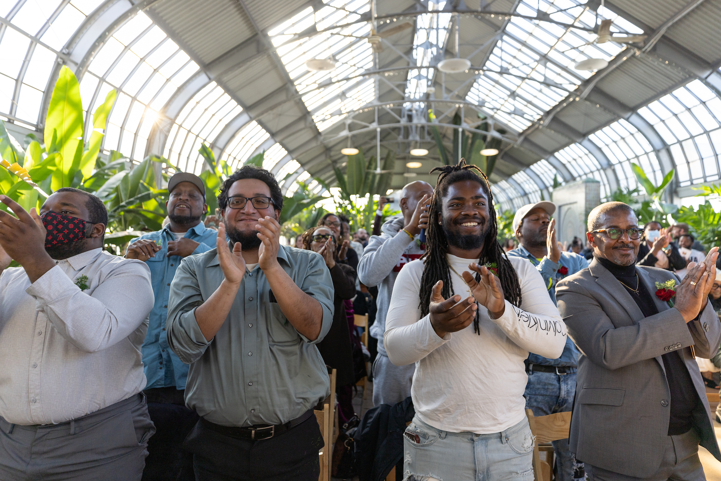 An audience stands and applauds during the Greencorps Chicago graduation ceremony 